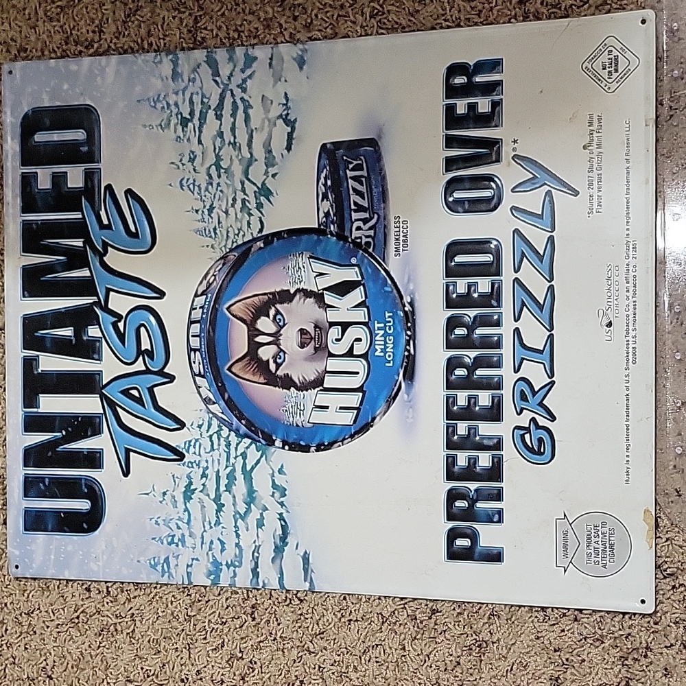 Tin sign untamed taste " husky over grizzly" 2007 19x15.5 approx